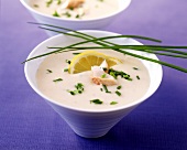 Creamed smoked fish soup with chives and lemon