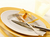 White plate with cutlery and physalis