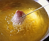 Cooking meat in fat on fondue fork