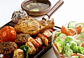 Mixed barbecue food on grill rack