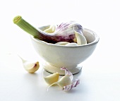 Garlic bulb and cloves of garlic in small bowl