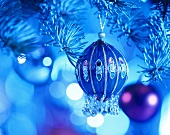 Decorated Christmas bauble in blue light