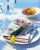 Spring place setting with fabric napkin and narcissus