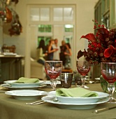 Table laid in green and red, people in background