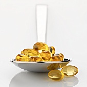 Vitamin E capsules on spoon