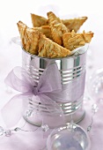 Triangular almond biscuits in a tin