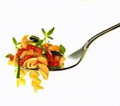 Wholemeal spiral pasta with vegetable sauce on fork