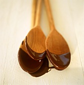 Melted chocolate on kitchen spoons