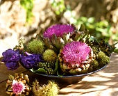 Autumnal arrangement of artichoke flowers and chestnuts