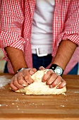Man kneading bread dough