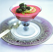 Blackberry mousse in glass with lime zest and blackberries