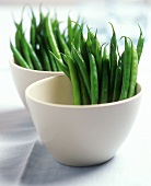 Green beans in white bowls