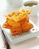 Wan tan (deep-fried pastry triangles with meat filling)