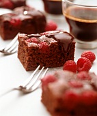 Piece of chocolate cake with raspberries and chocolate icing