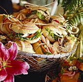 Open sandwiches on bread rolls in wire basket