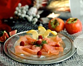 Smoked salmon decorated with raspberries and lemon slices