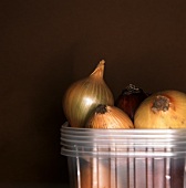 Onions in a pile of plastic containers