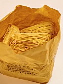 Asian egg noodles in a paper bag