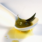 Green olive with olive oil on spoon