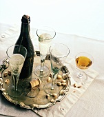 Bottle of sparkling wine with glasses and an aperitif