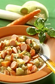 Spring vegetable stew with sausages