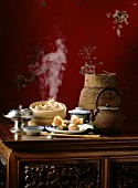 Chinese table scene with dim sum and tea