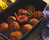 Stewed quinces with cinnamon & vanilla pods in roasting tin