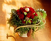 Christmassy bouquet with red roses and fir cones