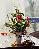 Spring bouquet of tulips in vase, Easter eggs beside it