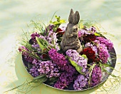 Arrangement of lilac with Easter Bunny on a plate