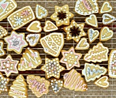 Several Christmas biscuits, decorated in pastel colours