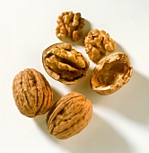 Two whole and one opened walnut