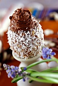 Egg-shaped chocolate mousse with grated coconut