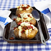 Baked potatoes with cheese and tomato filling