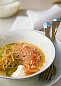 Salmon in Riesling stock with strips of vegetables 
