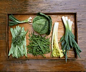 Assorted green vegetables on wooden background