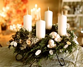 Advent wreath with white candles and white decoration