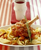 Braised lamb shank with vegetable sauce on ribbon pasta