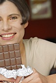Woman holding a bar of chocolate