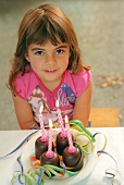 Girl with choc marshmallows & birthday candles (grainy effect)