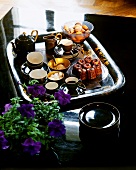 Tray with coffee, tea, French canneles and macaroons