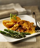 Chicken with apricot sauce and green asparagus
