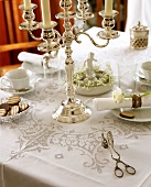 Table laid for coffee with silver chandelier