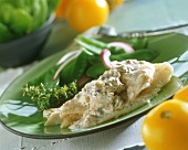 Fish fillet with mushroom and cream sauce and mangetouts