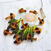 Green asparagus with mushrooms and fried egg 