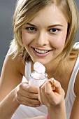 Young woman eating fruit yoghurt