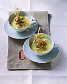 Two dishes of potato soup with scallops