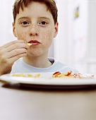 Boy holding chips in his hand