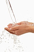 Water being poured over two hands