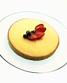Lemon tart garnished with strawberries and blueberries